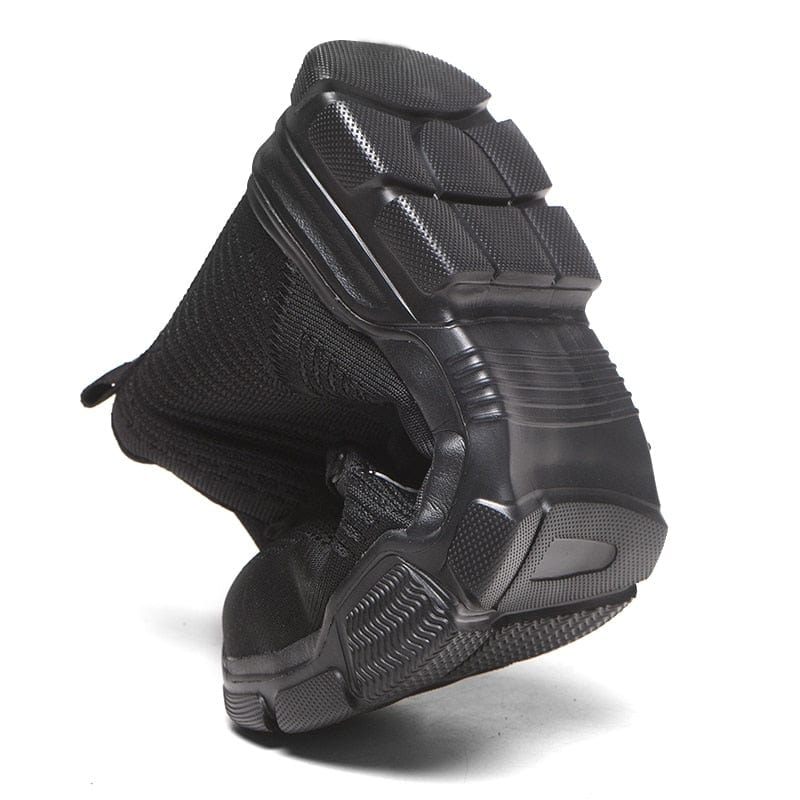 Black shoe being bent in half to show flexibility of the sole 800 x 800